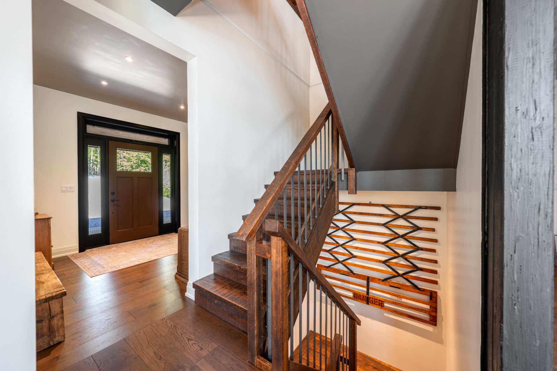 Foyer with reclaimed timber staircase and vintage ski rack