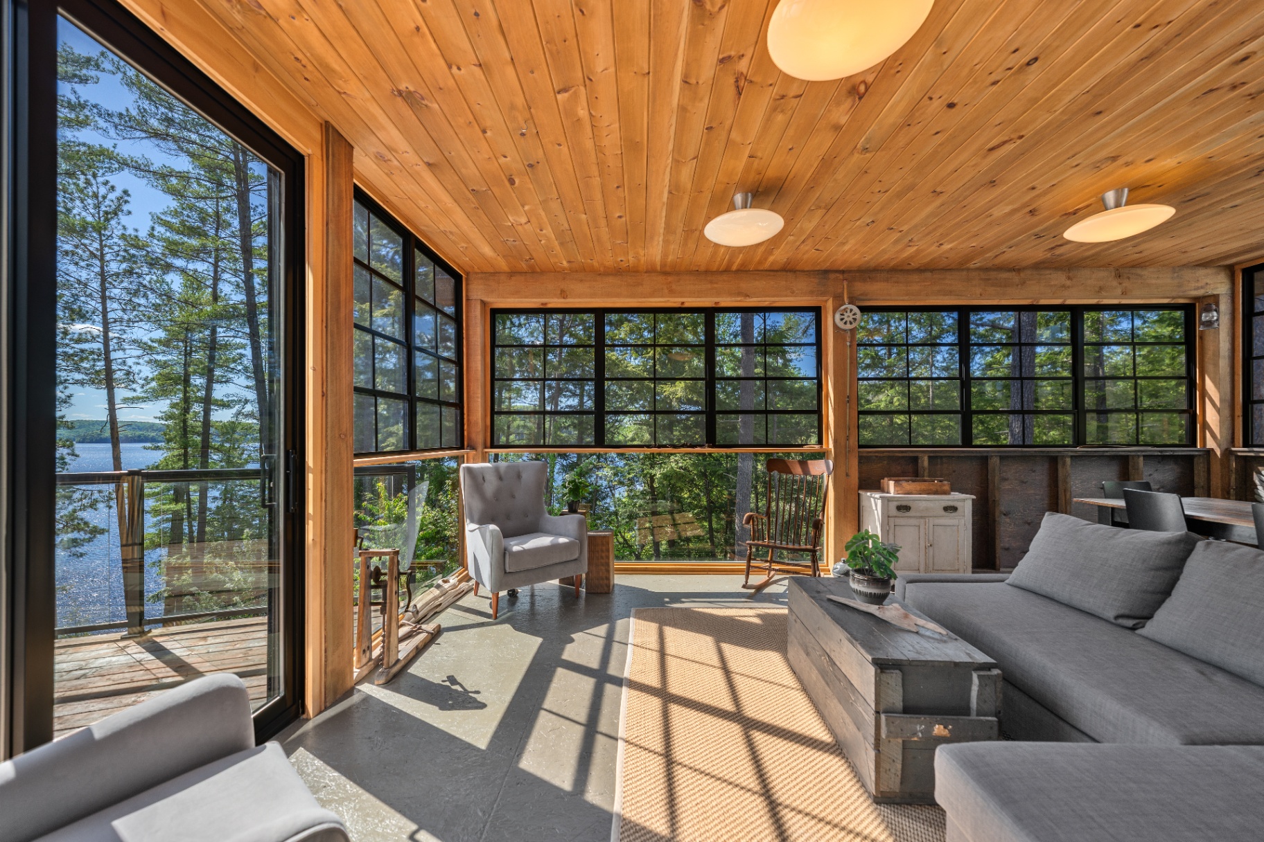Screened porch with sectional and lake outlook