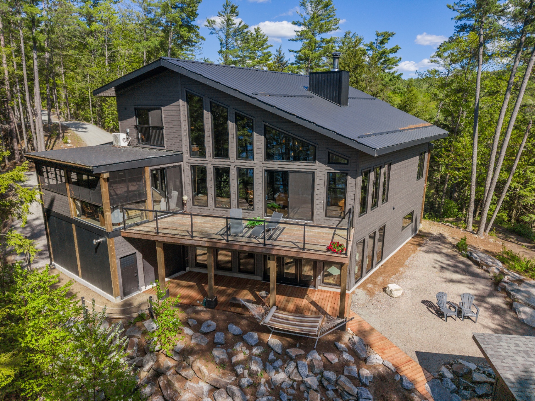 Elevated rear exterior highlighting the wall of glass and screened room