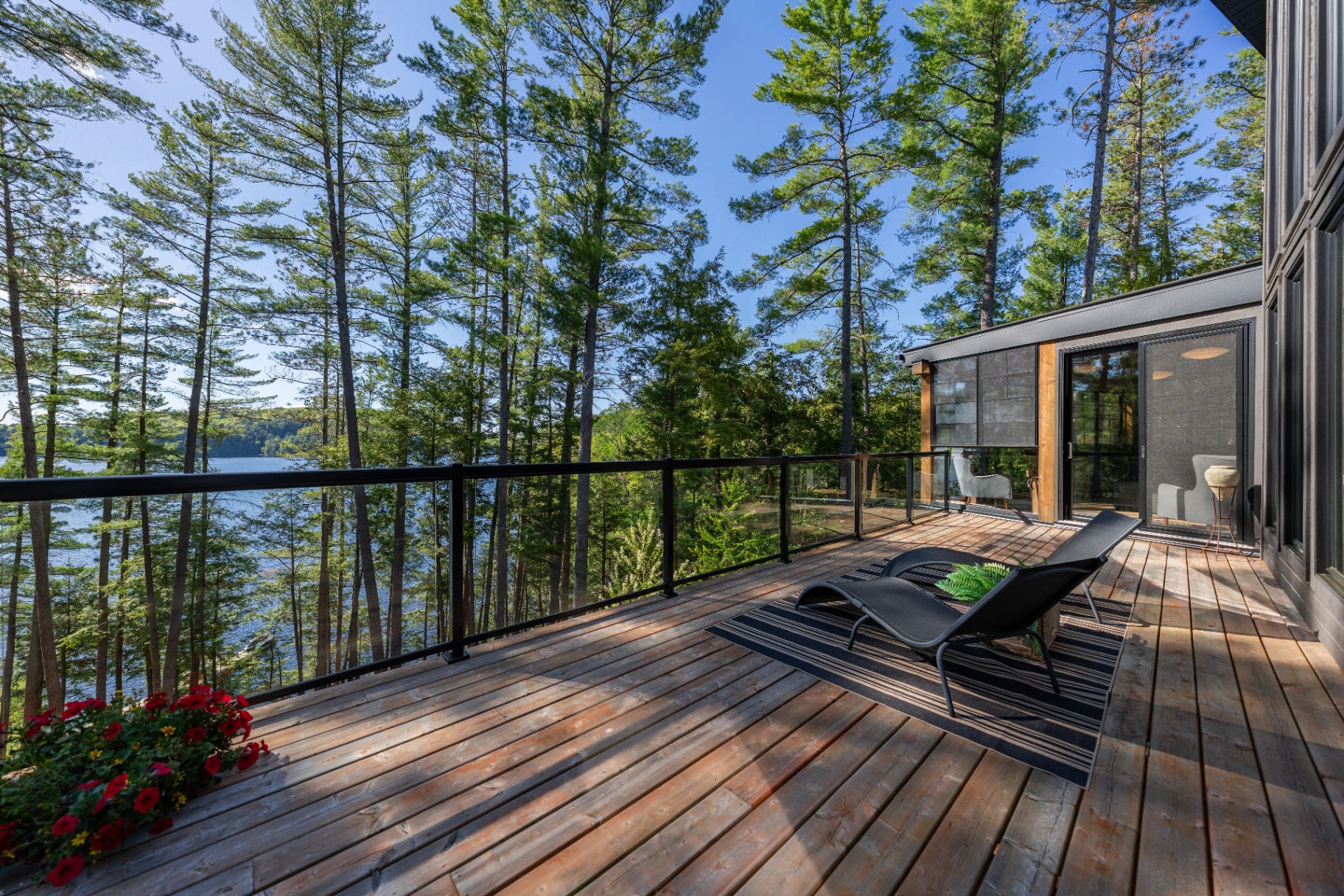 Wraparound upper deck with glass railing and lake views