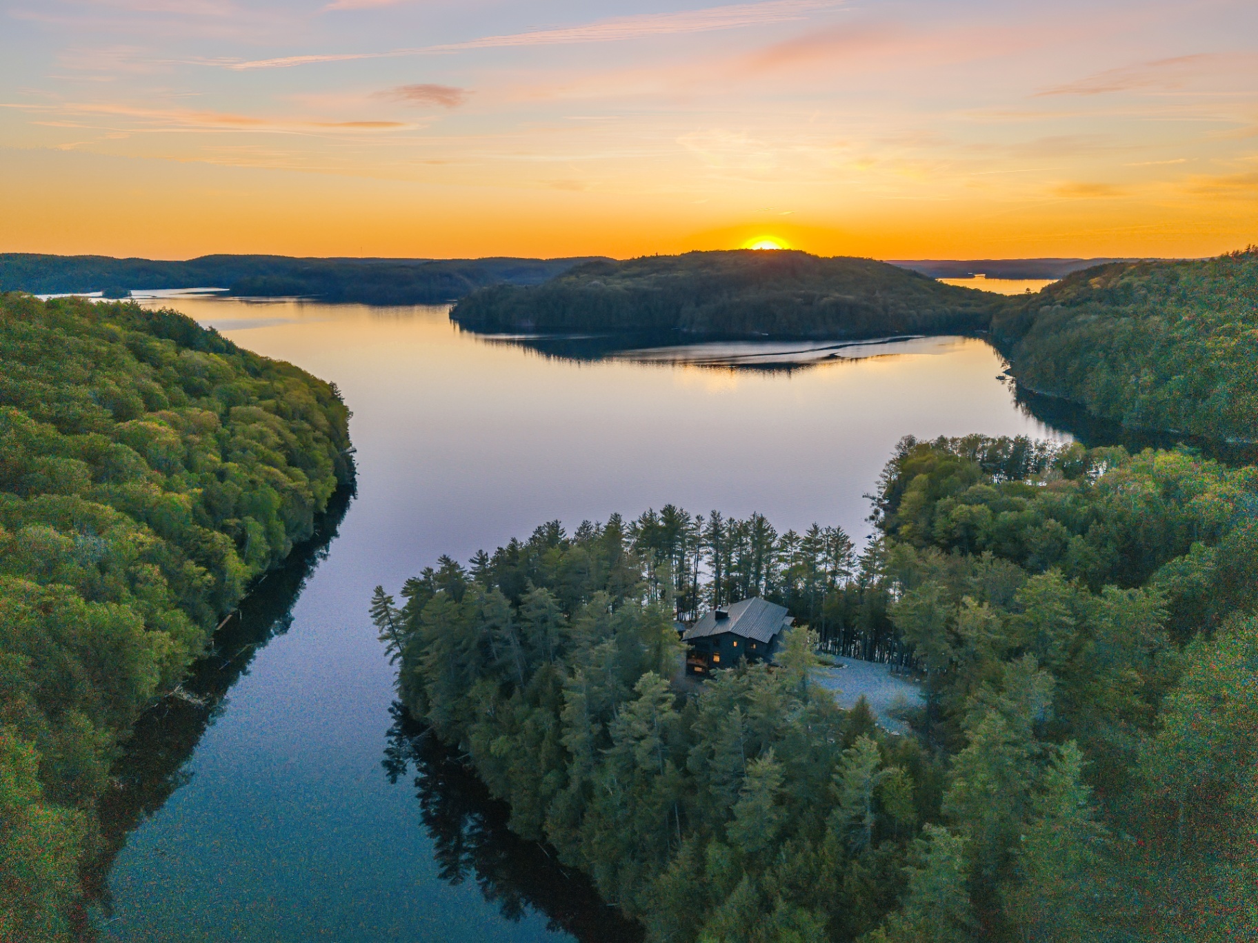 Sweeping aerial sunset over the peninsula point and surrounding Redstone Lake