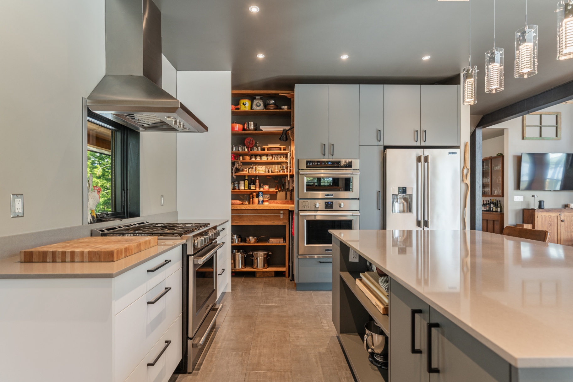 Kitchen island, range, and open pantry shelving