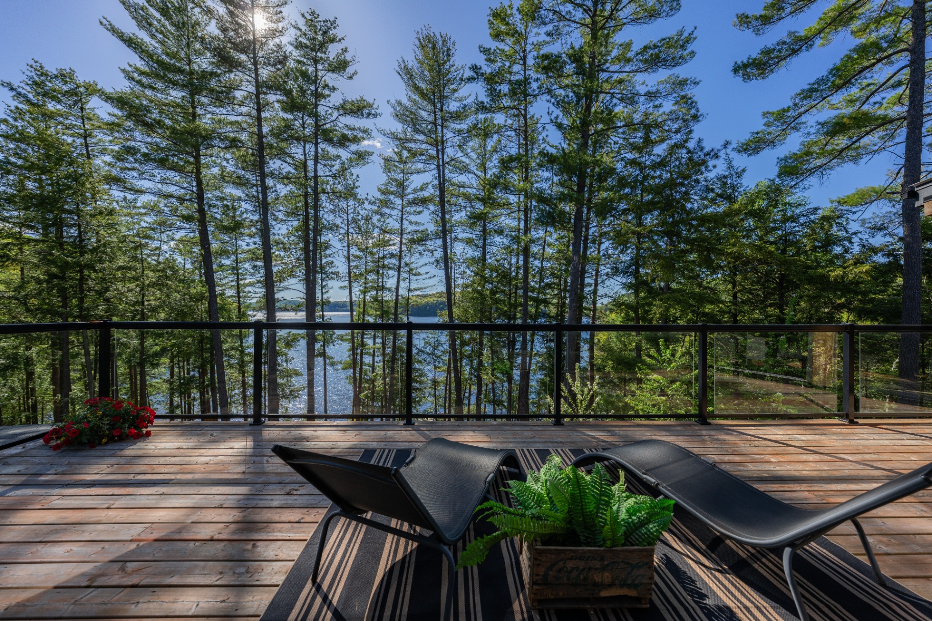 Upper deck lounge chairs overlooking Redstone Lake through the pines