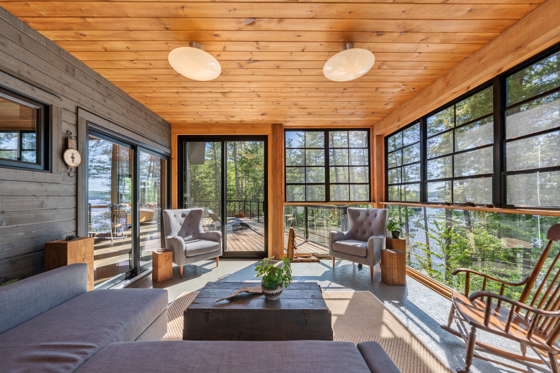 Screened porch toward deck door with armchairs