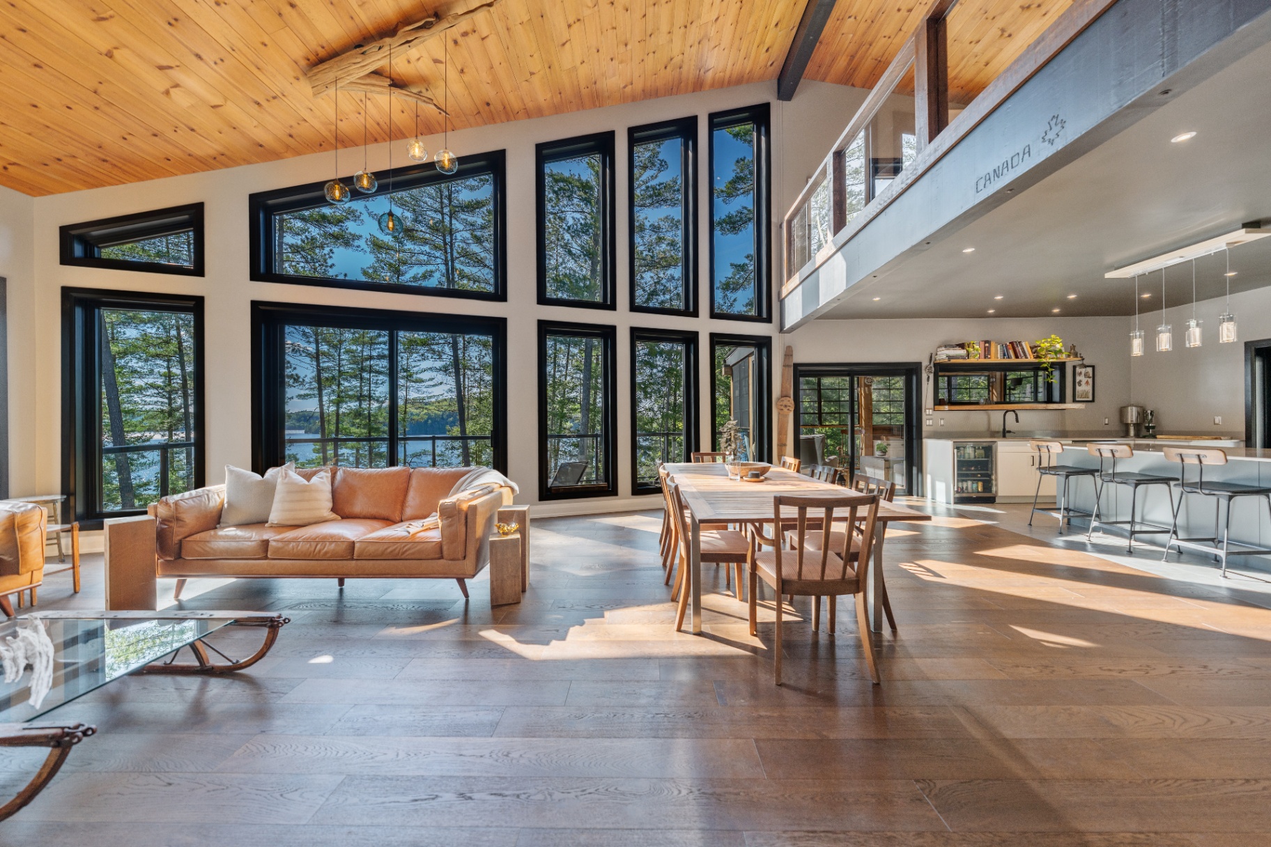 Open-plan great room with cathedral ceiling and lake views