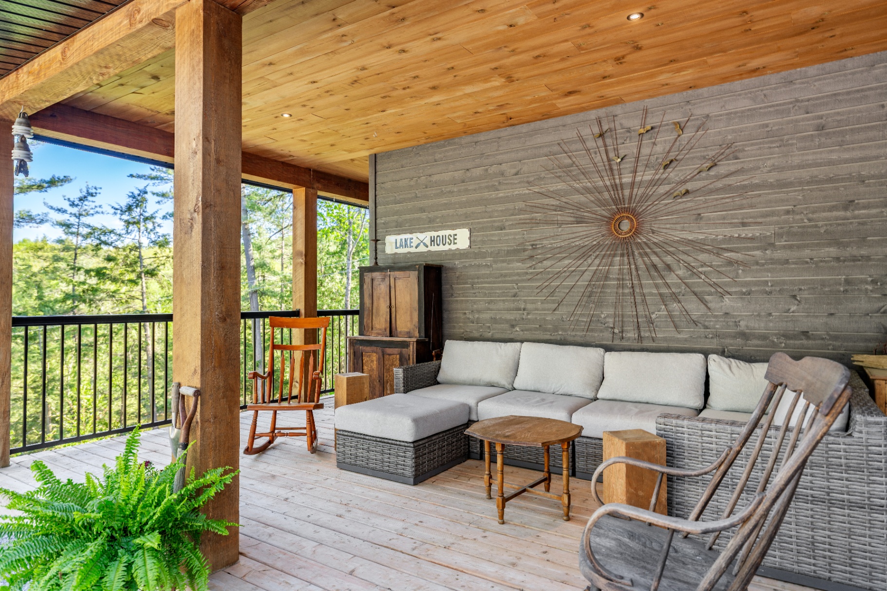 Covered porch with lake house sign and lounge