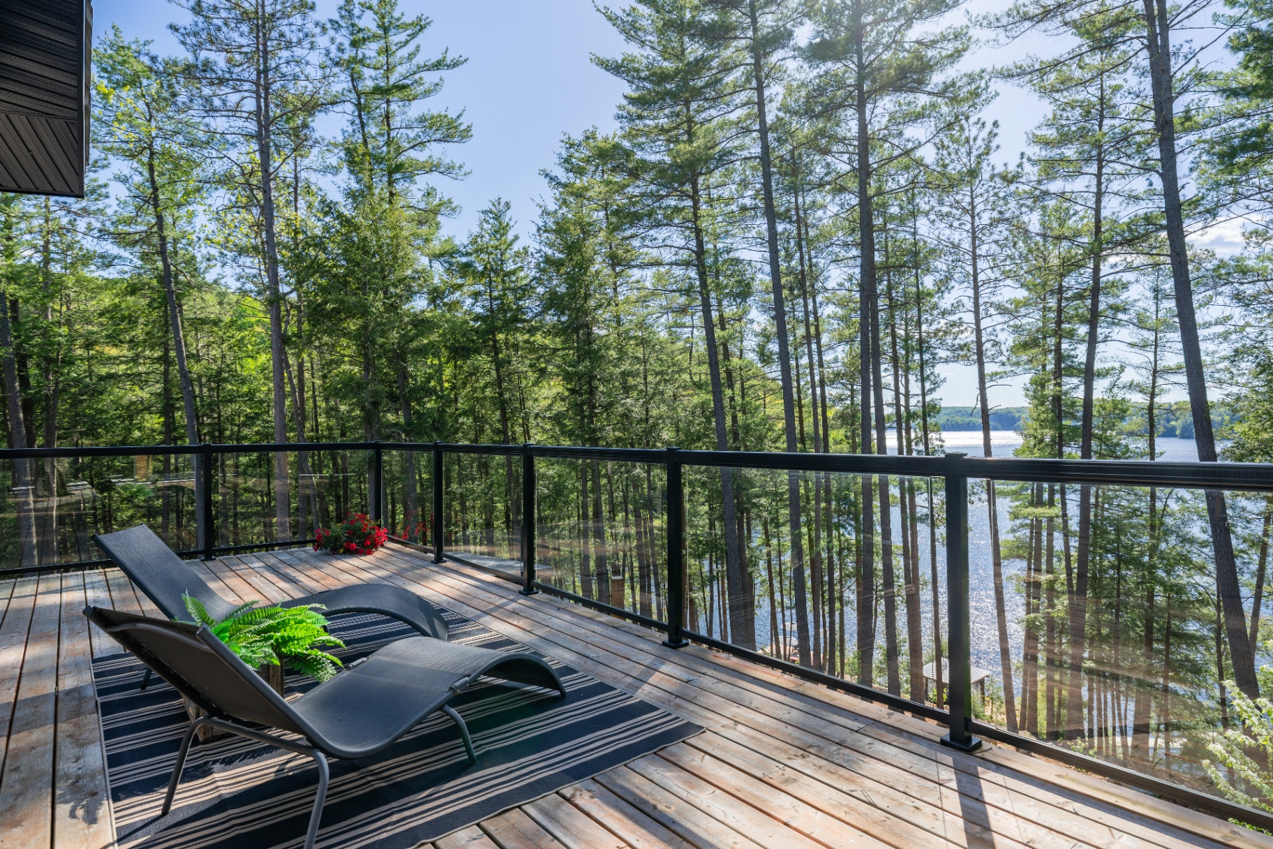 Lake-facing deck corner with chaise loungers and elevated water views