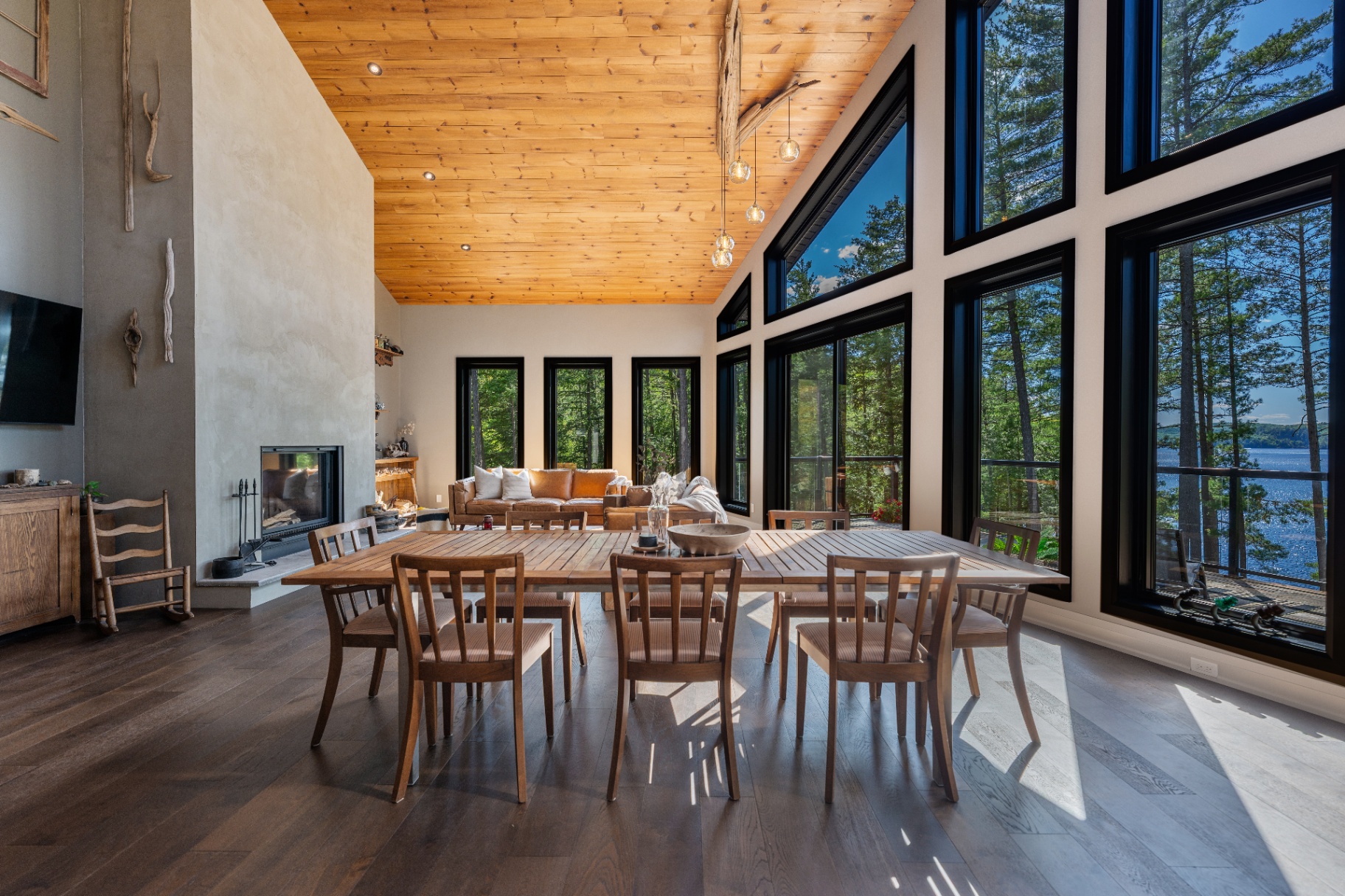 Great room with fireplace, dining, and lake views