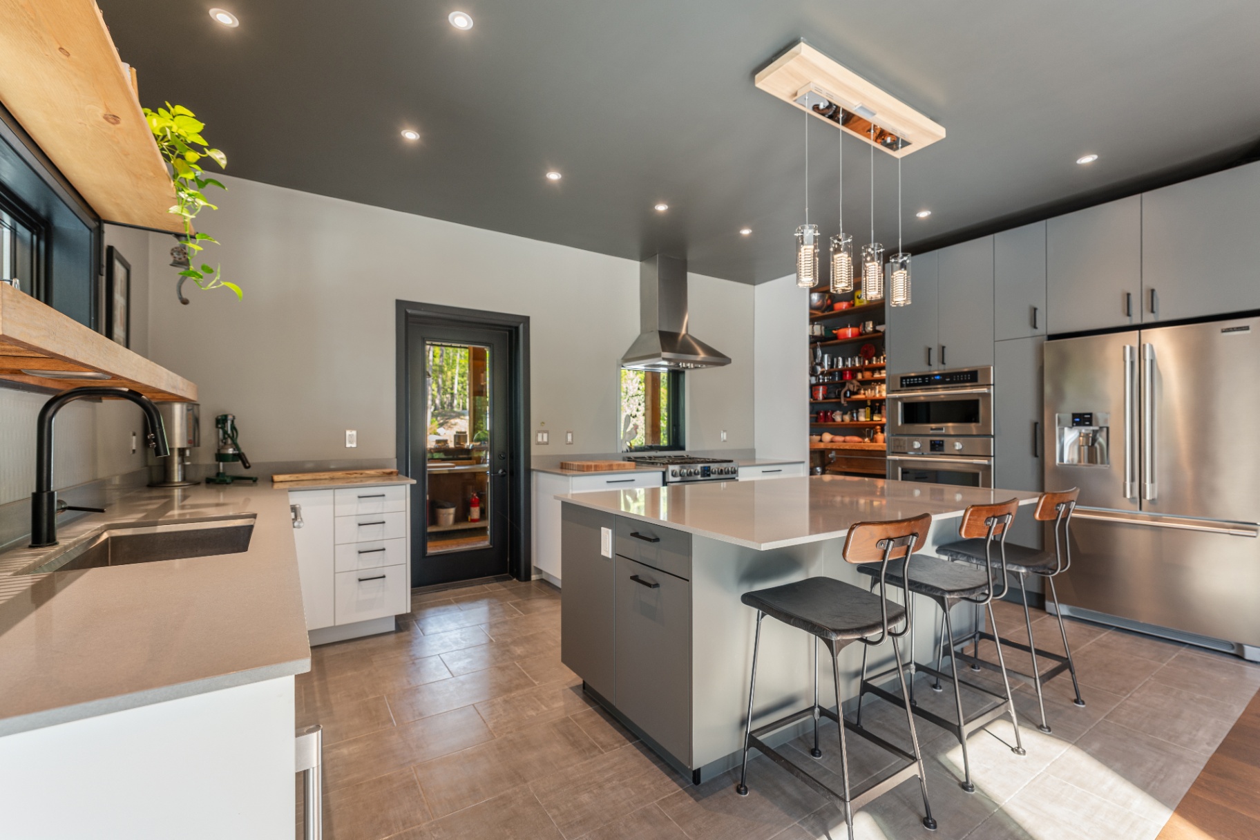 Kitchen with grey cabinetry and stainless appliances