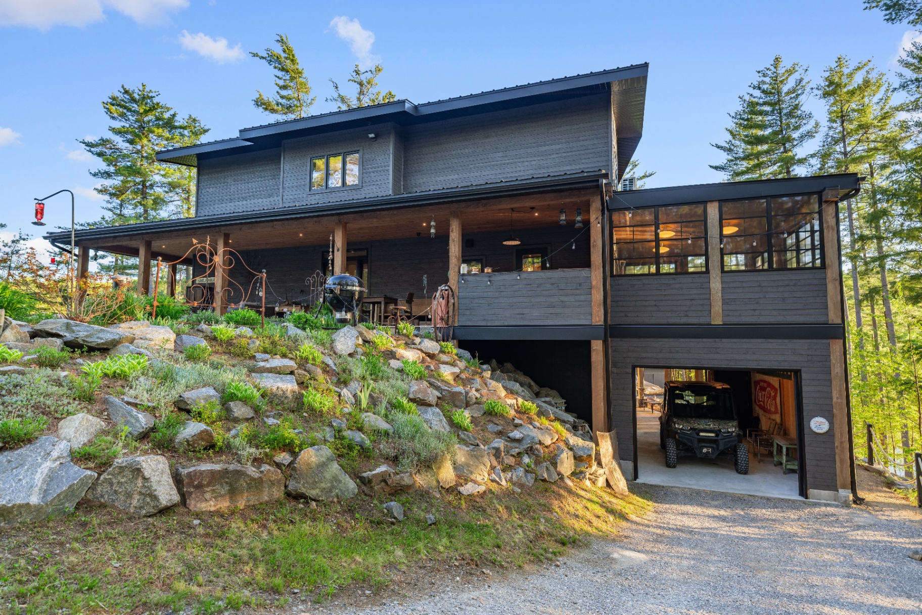 Rear elevation of the cottage with covered porch, garage, and screened sunroom