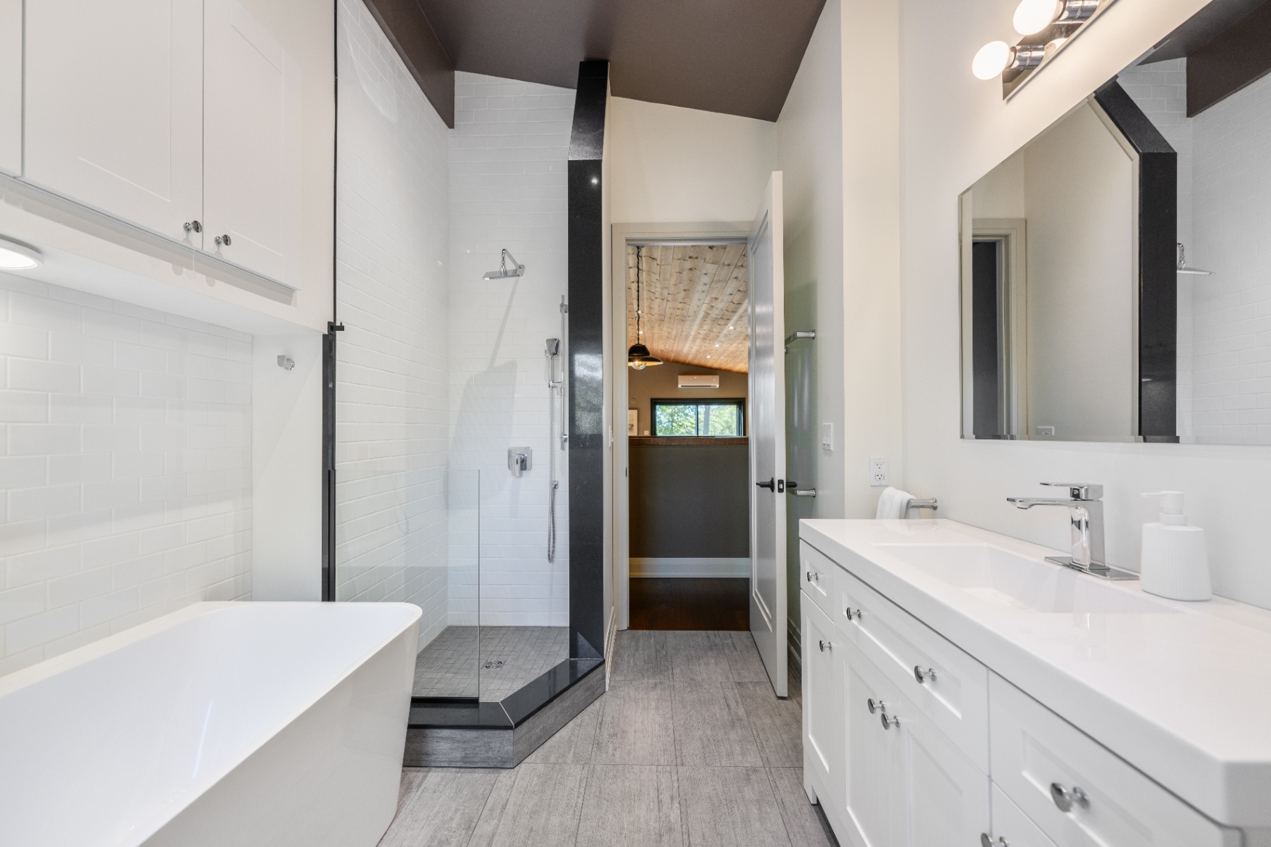 Primary bathroom with freestanding tub, glass shower, and double vanity
